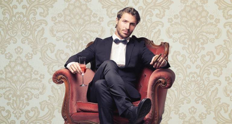 man in a tux in a chair