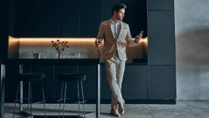 man in suit standing in modern house