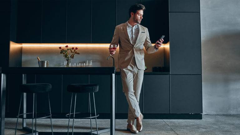 man in suit standing in modern house